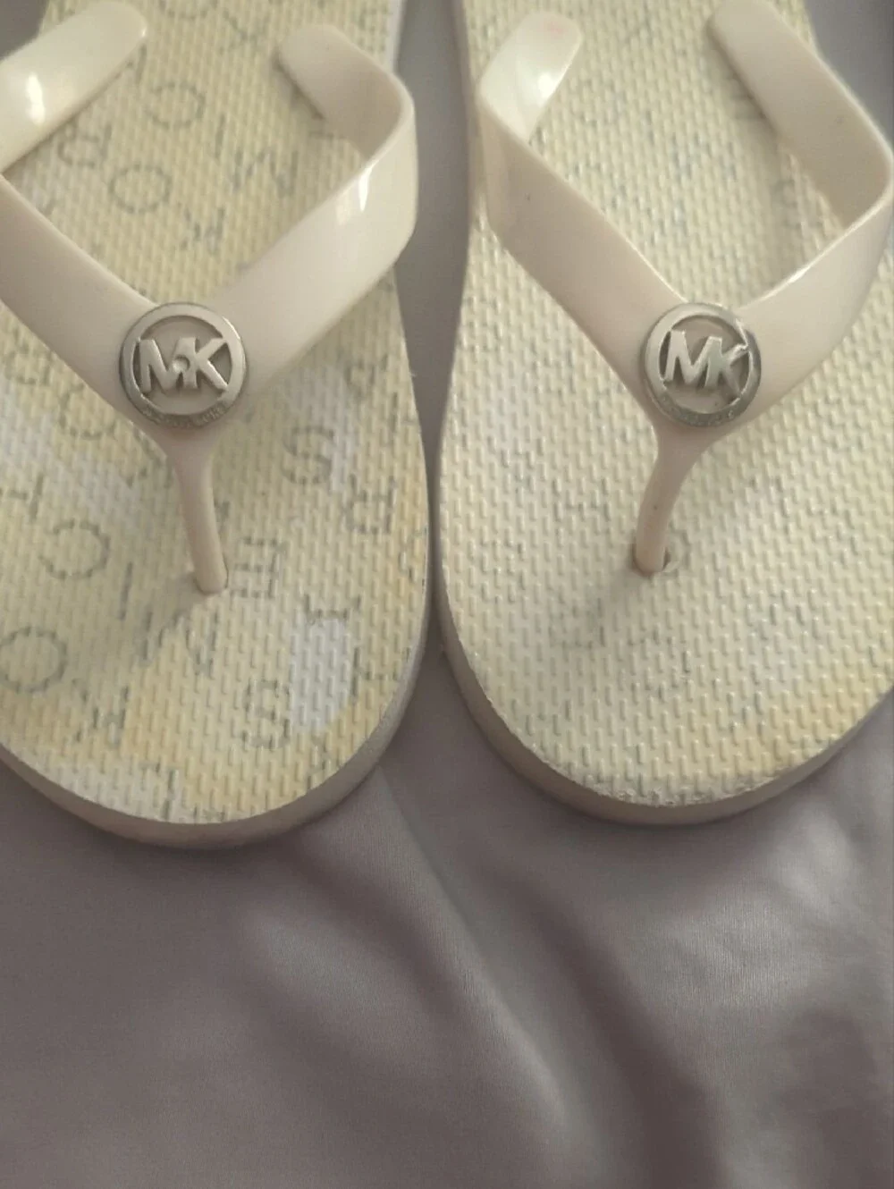 Michael Kors White Flip Flop with Silver MK Medallion